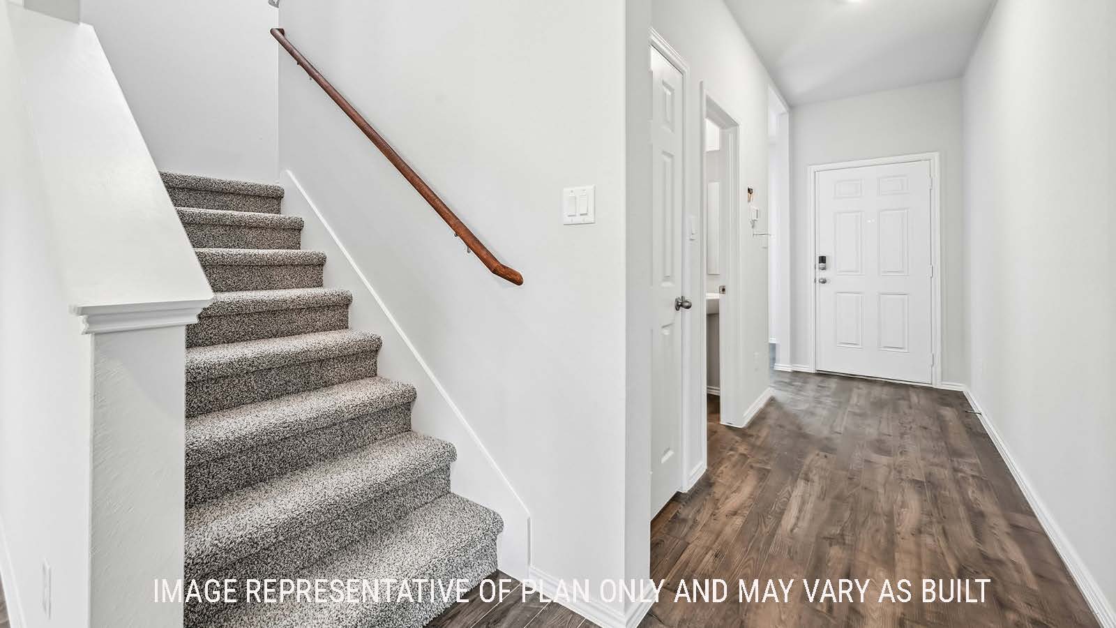 Madison hallway on the first floor with view of stairs to second floor and entry way.