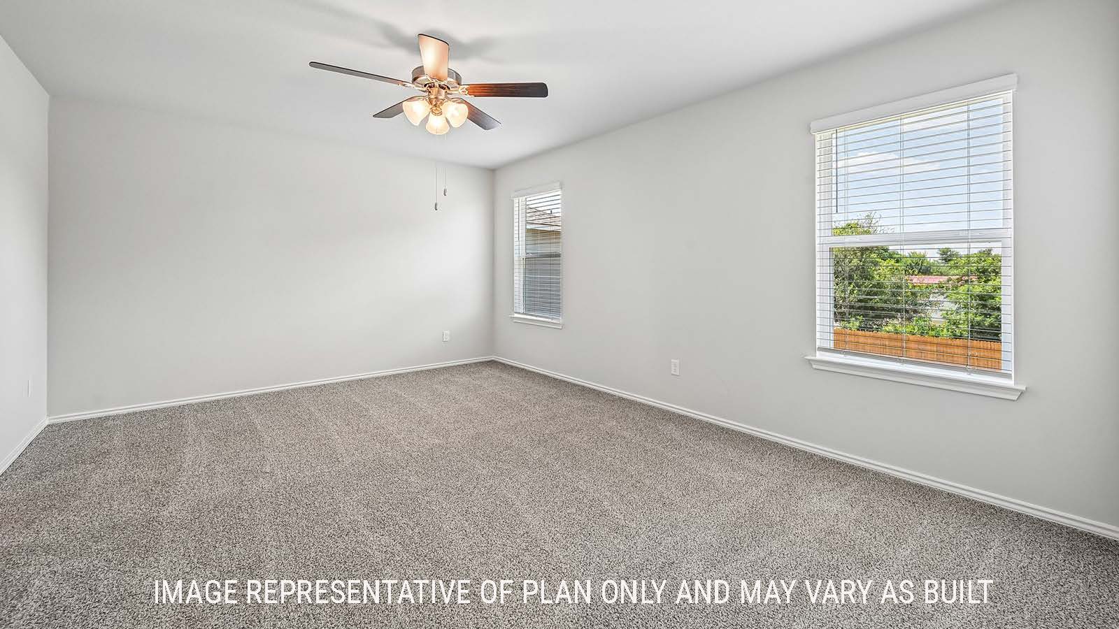 Madison primary bedroom with carpeted flooring and windows for natural lighting.