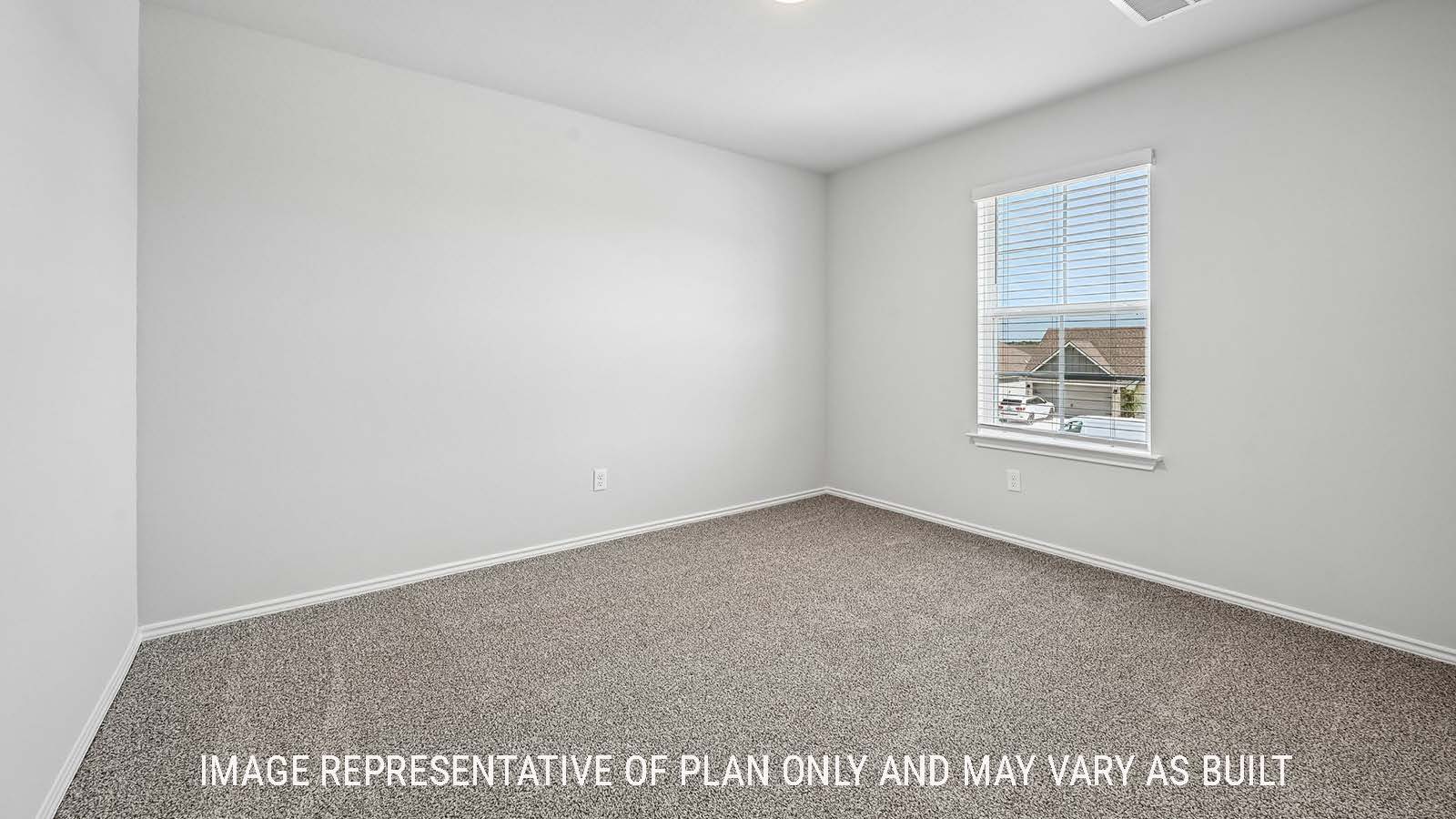 Madison secondary bedroom with carpeted flooring and window for natural lighting.