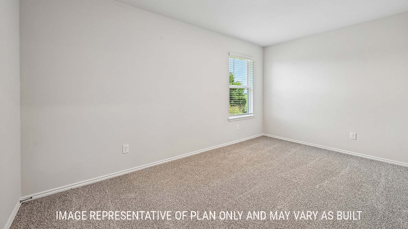 Madison secondary bedroom with carpeted flooring and window for natural lighting.