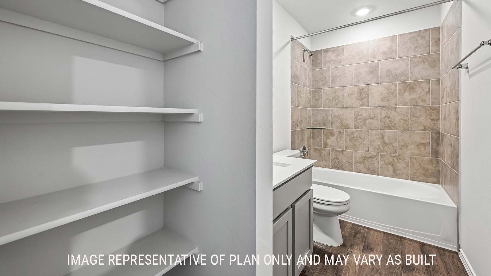 Madison secondary bathroom with shelving for storage and view of shower and tub combo.