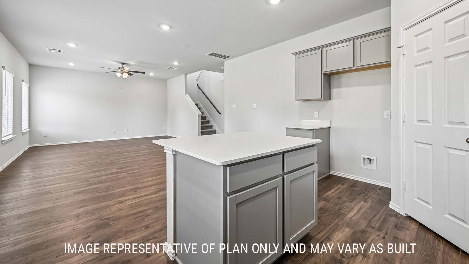 Madison kitchen with kitchen island and view of open concept dining room and living room.