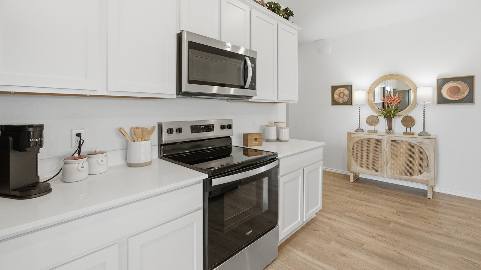 Ranch San Gabriel kitchen with white cabinets and granite countertops and view of front entry hallway.