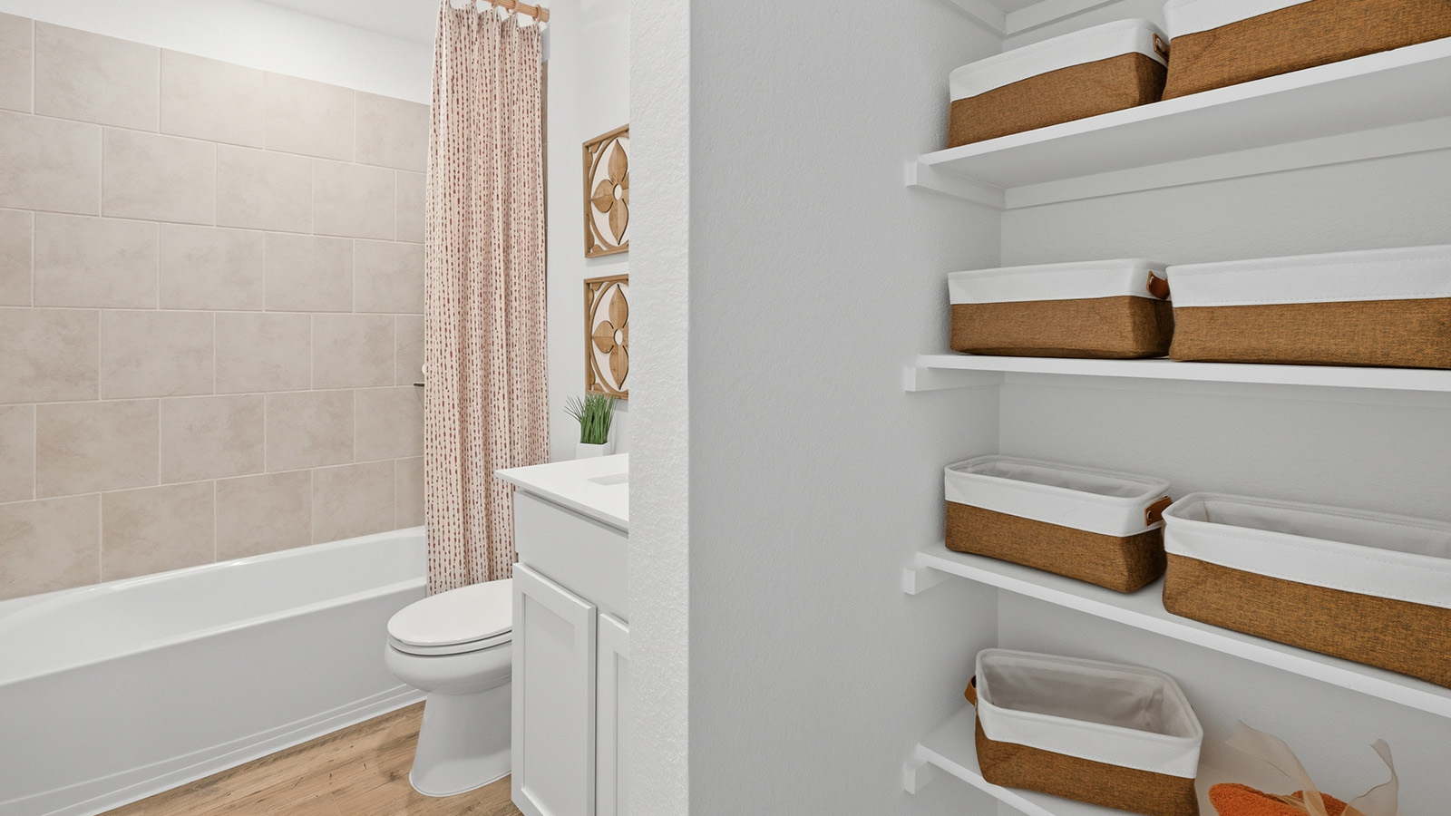Ranch San Gabriel secondary bathroom with shelving for storage and view of  tub and shower combo.