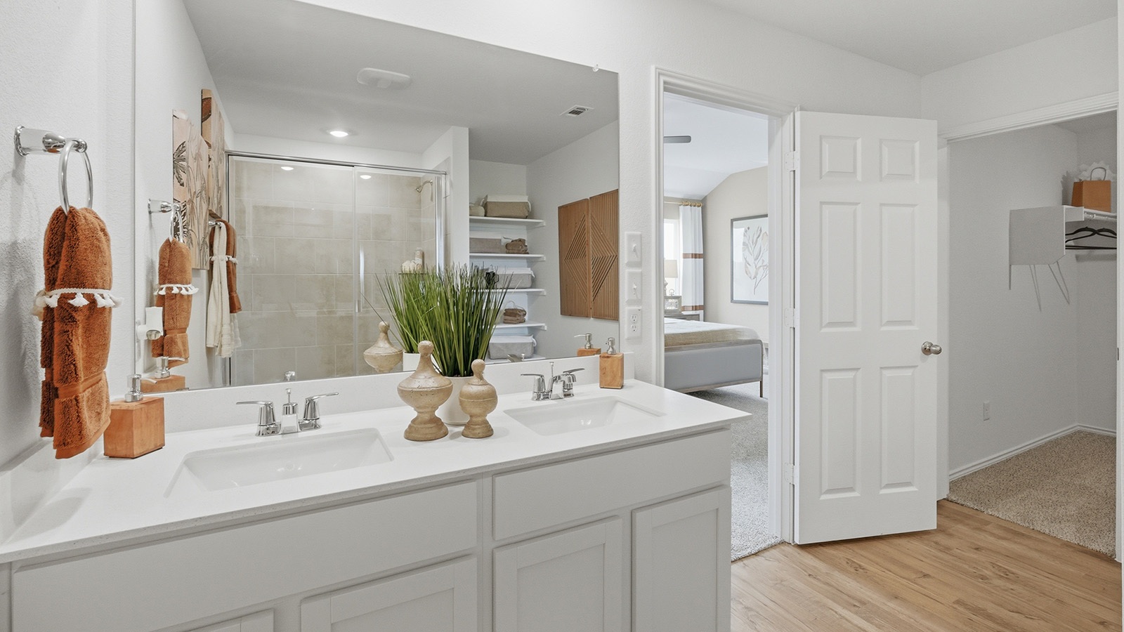 Ranch San Gabriel primary bathroom with double vanity sink and view of primary bedroom.