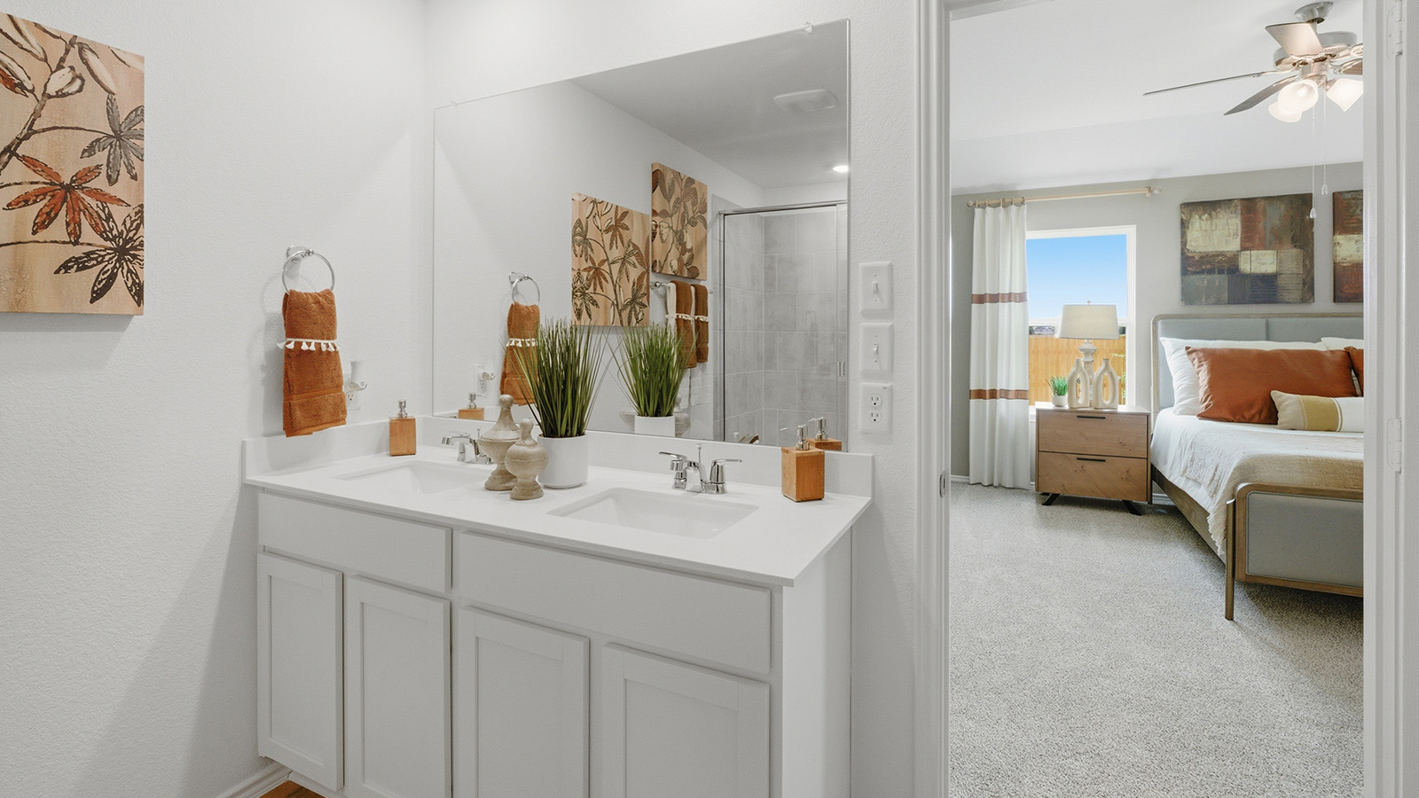 Ranch San Gabriel primary bathroom with double vanity sink and view of primary bedroom.