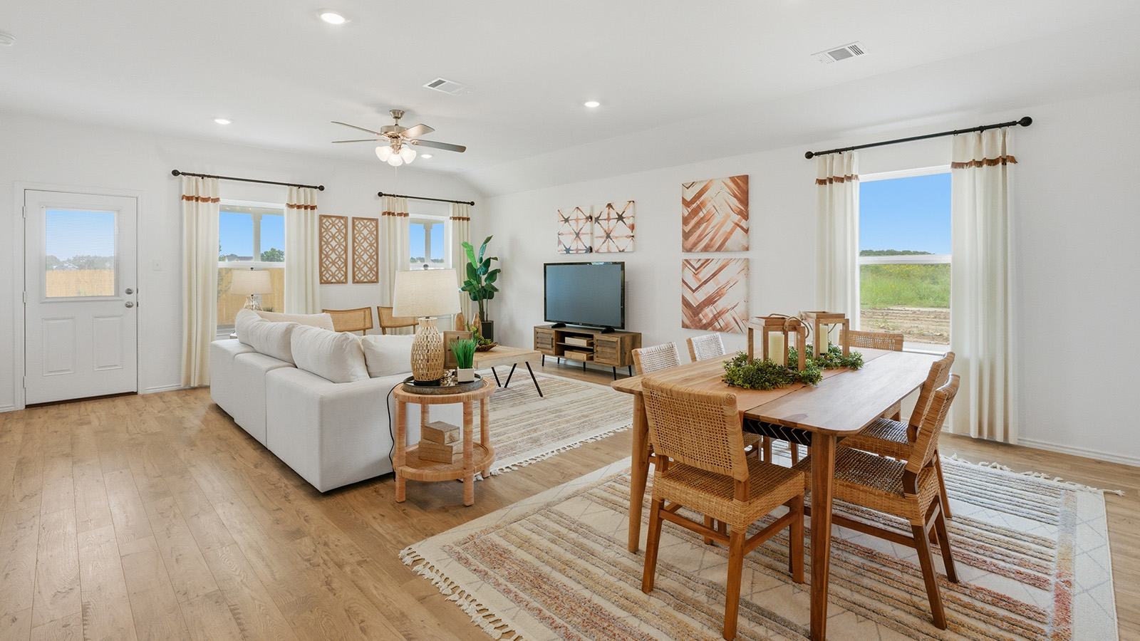 Ranch San Gabriel dining room with view of open concept living room and windows for natural lighting.