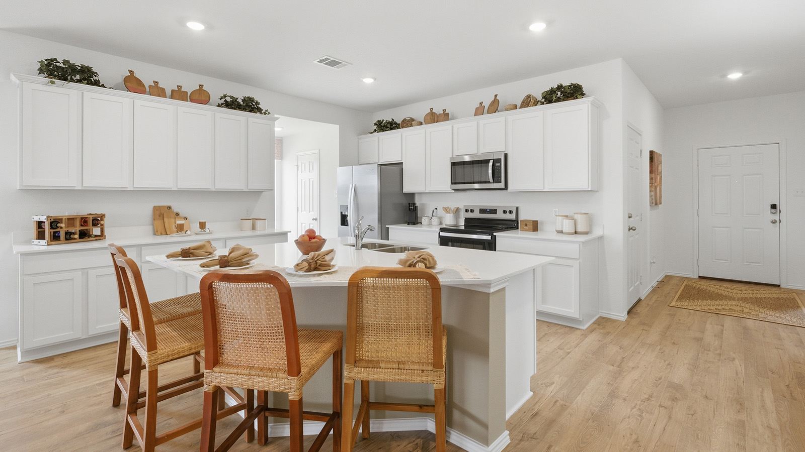 Rancho San Gabriel kitchen with kitchen island and view to front entry way.
