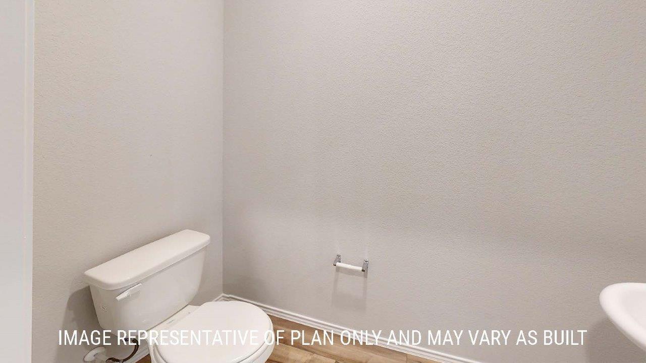 Emma half bath with vanity sink and vinyl plank flooring.