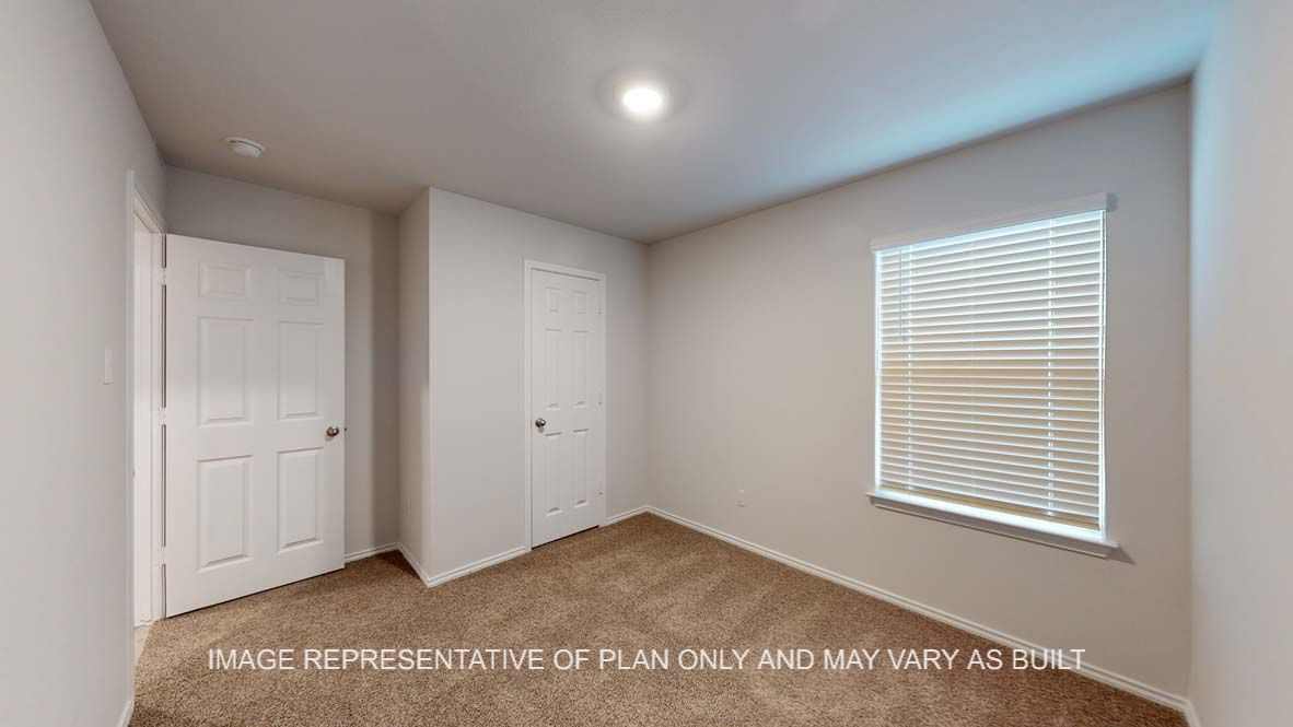 Ashburn secondary bedroom with carpet flooring and window.
