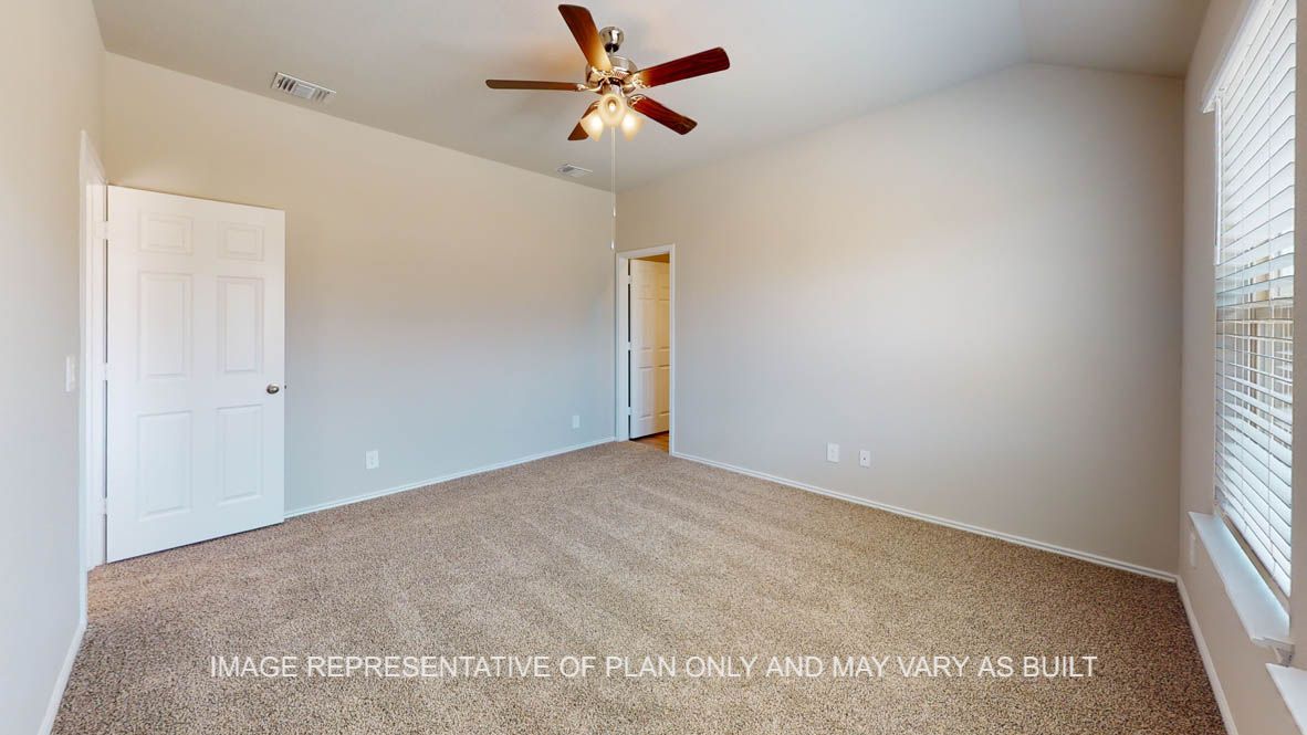 Elgin primary bedroom with carpet flooring and ceiling fan.
