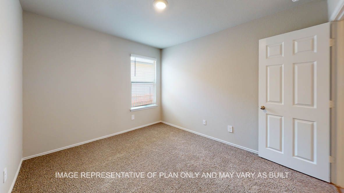 Elgin secondary bedroom with carpet flooring and window.