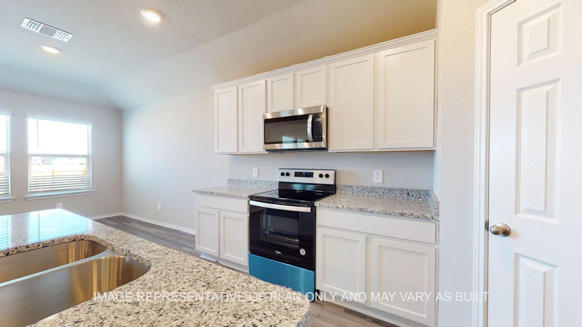 Fargo kitchen with white cabinets and granite countertops.