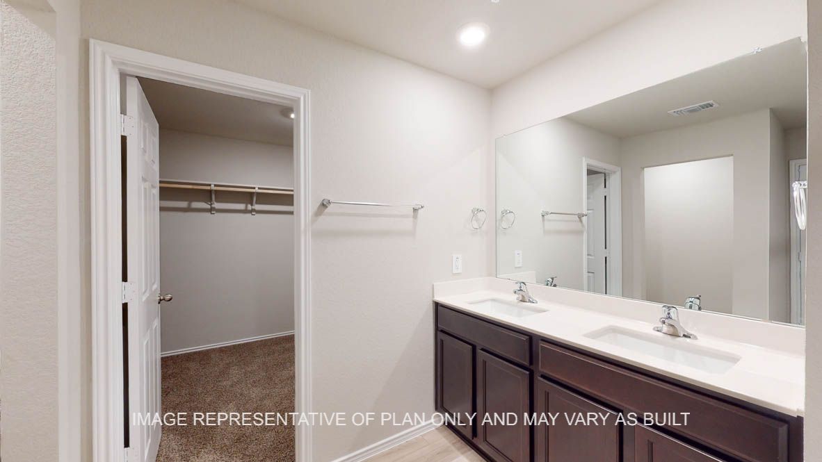 Texas Cali primary bath with dark cabinets and white countertops.