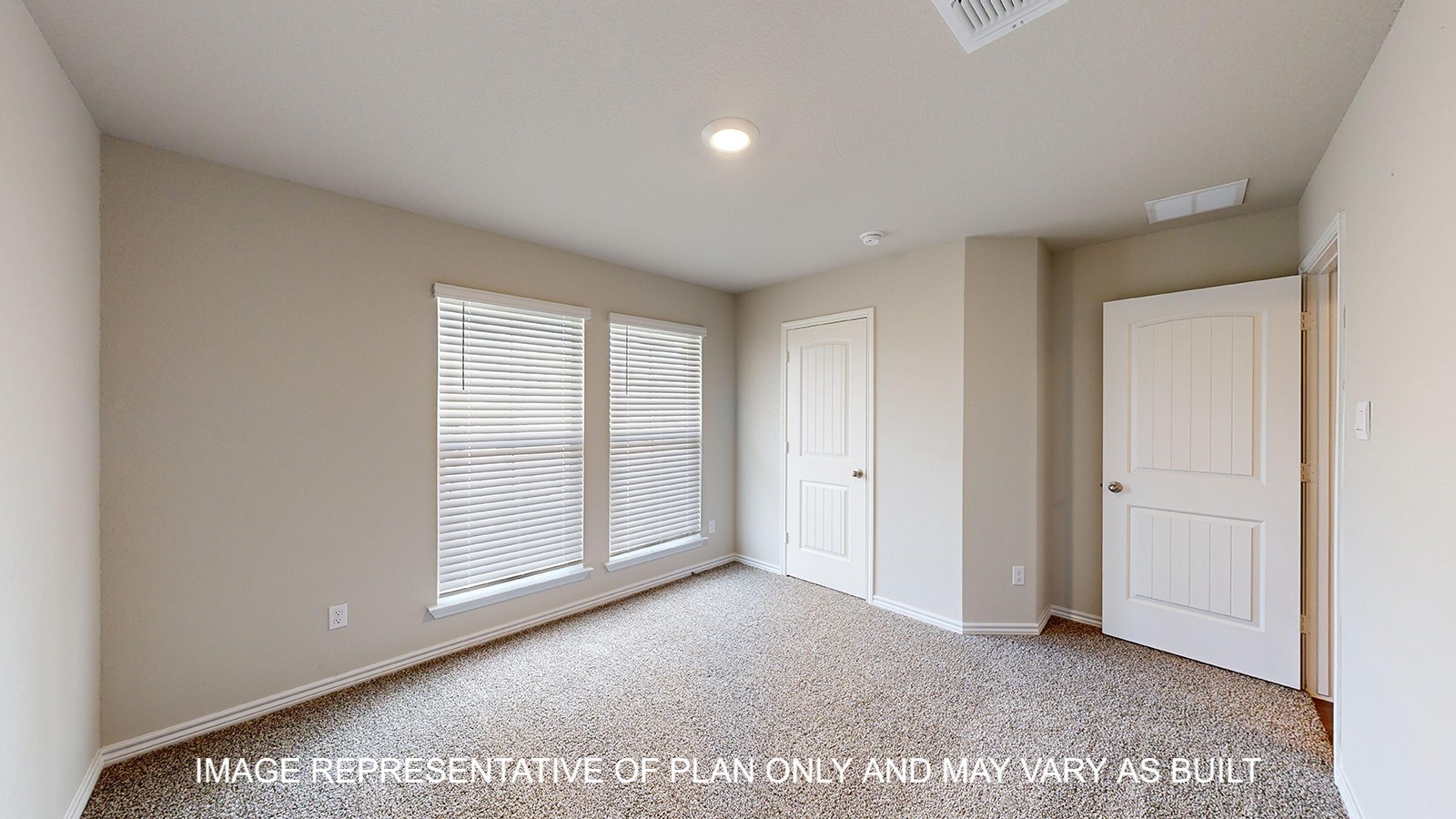 Monroe secondary bedroom with carpet flooring and windows.
