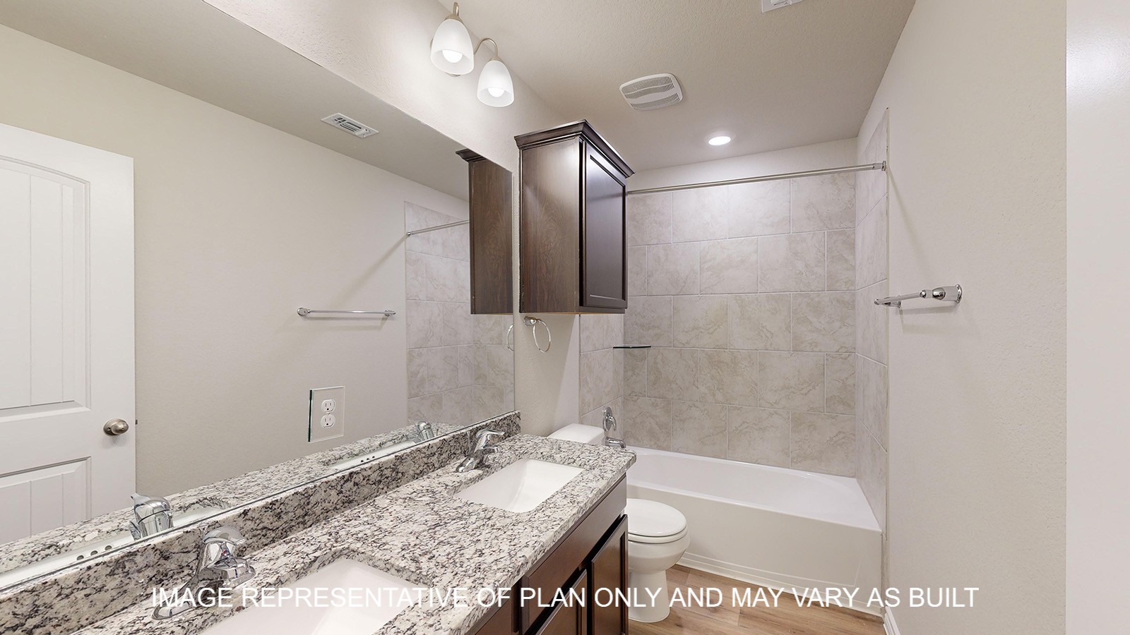 Monroe secondary bathroom with tub and shower combination and granite countertops.
