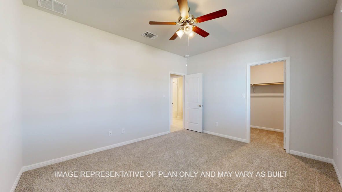 Parker secondary bedroom with carpet flooring and windows.