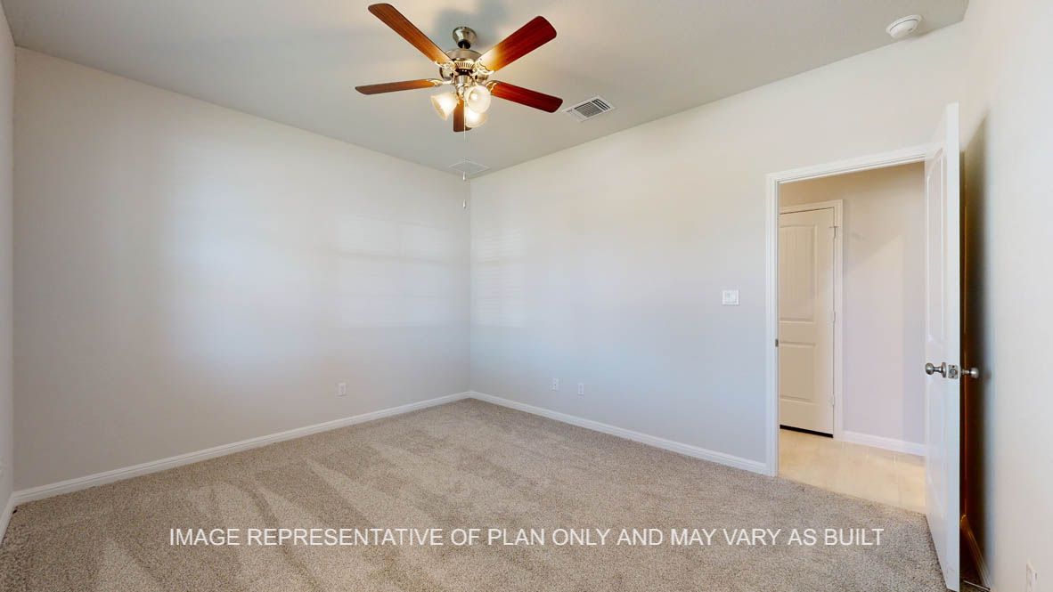 Parker secondary bedroom with carpet flooring and windows.