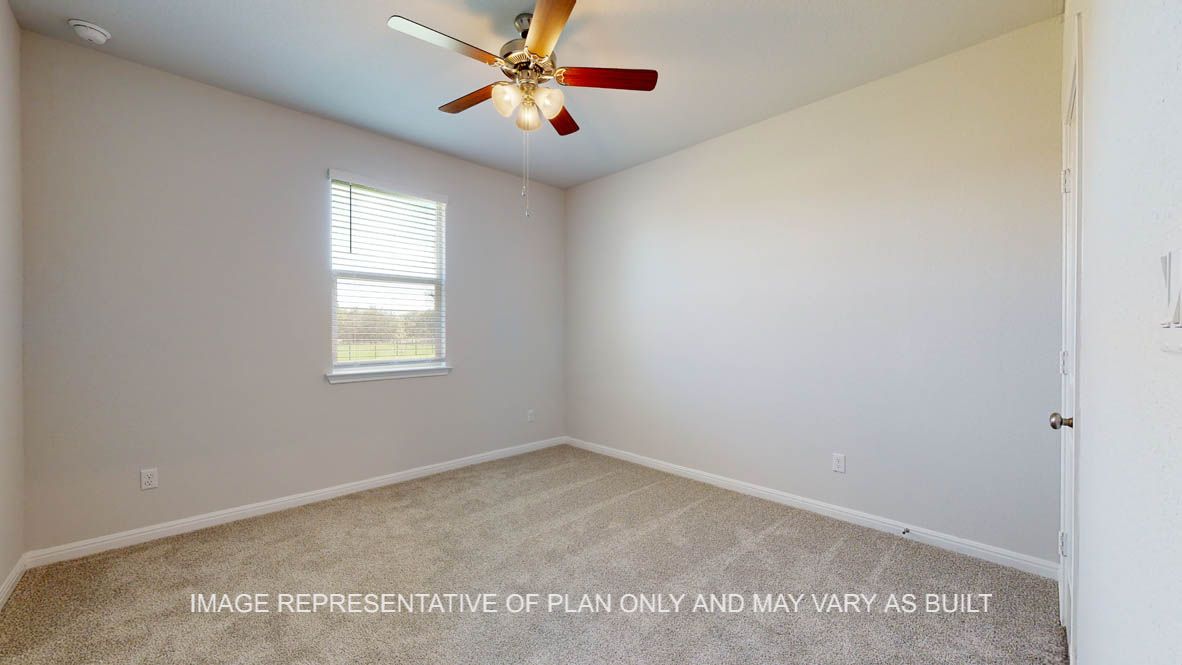 Parker secondary bedroom with carpet flooring and windows.