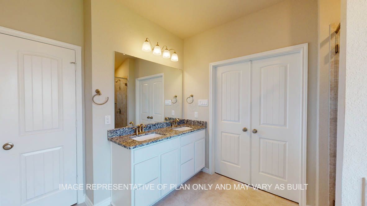Kiawa primary bathroom with white cabinets and granite countertops.