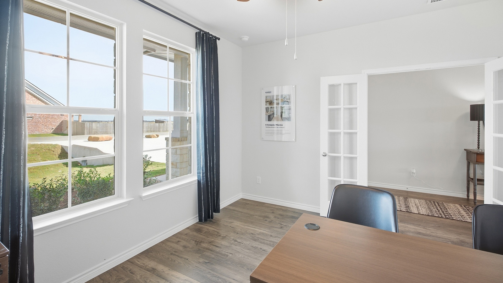 Homestead Model study office with vinyl flooring and windows for natural lighting.