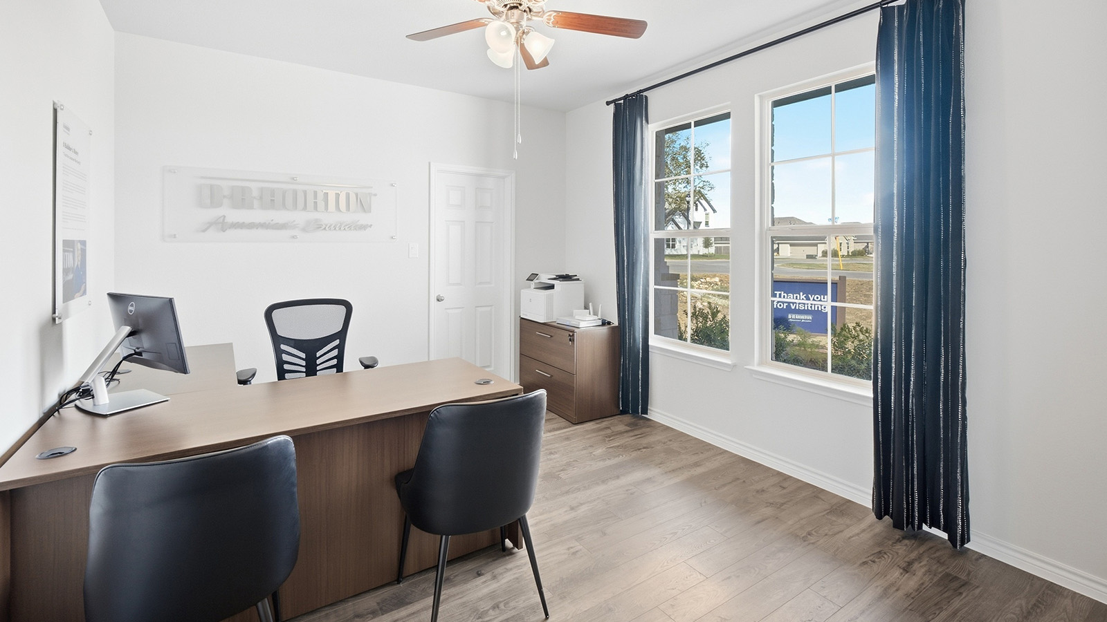 Homestead Model study office with vinyl flooring and windows for natural lighting.
