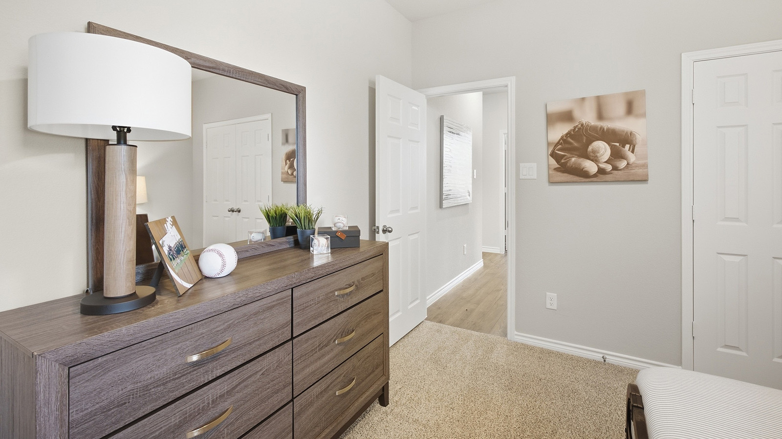 Homestead Model secondary bedroom with carpeted flooring and view of front hallway.