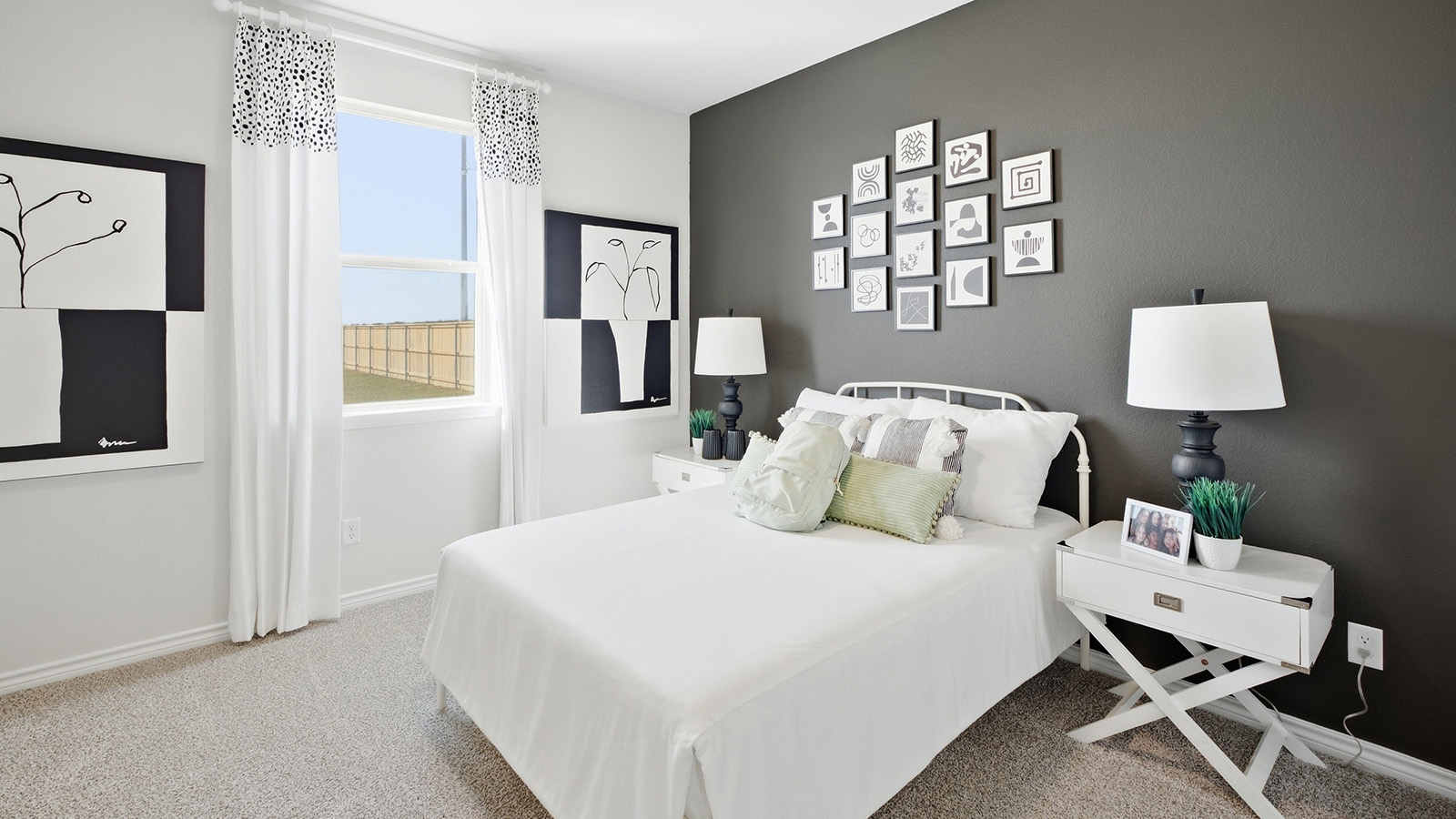 Homestead Model secondary bedroom with carpeted flooring and window for natural lighting.