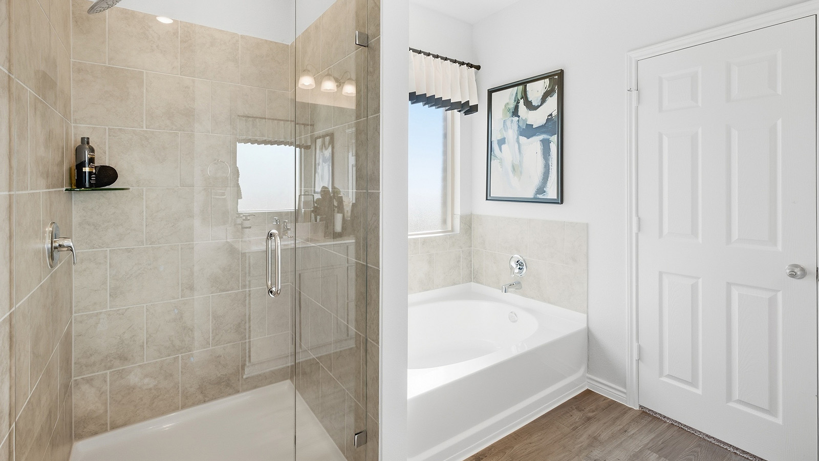 Homestead Model primary bathroom with walk-in shower and garden tub.