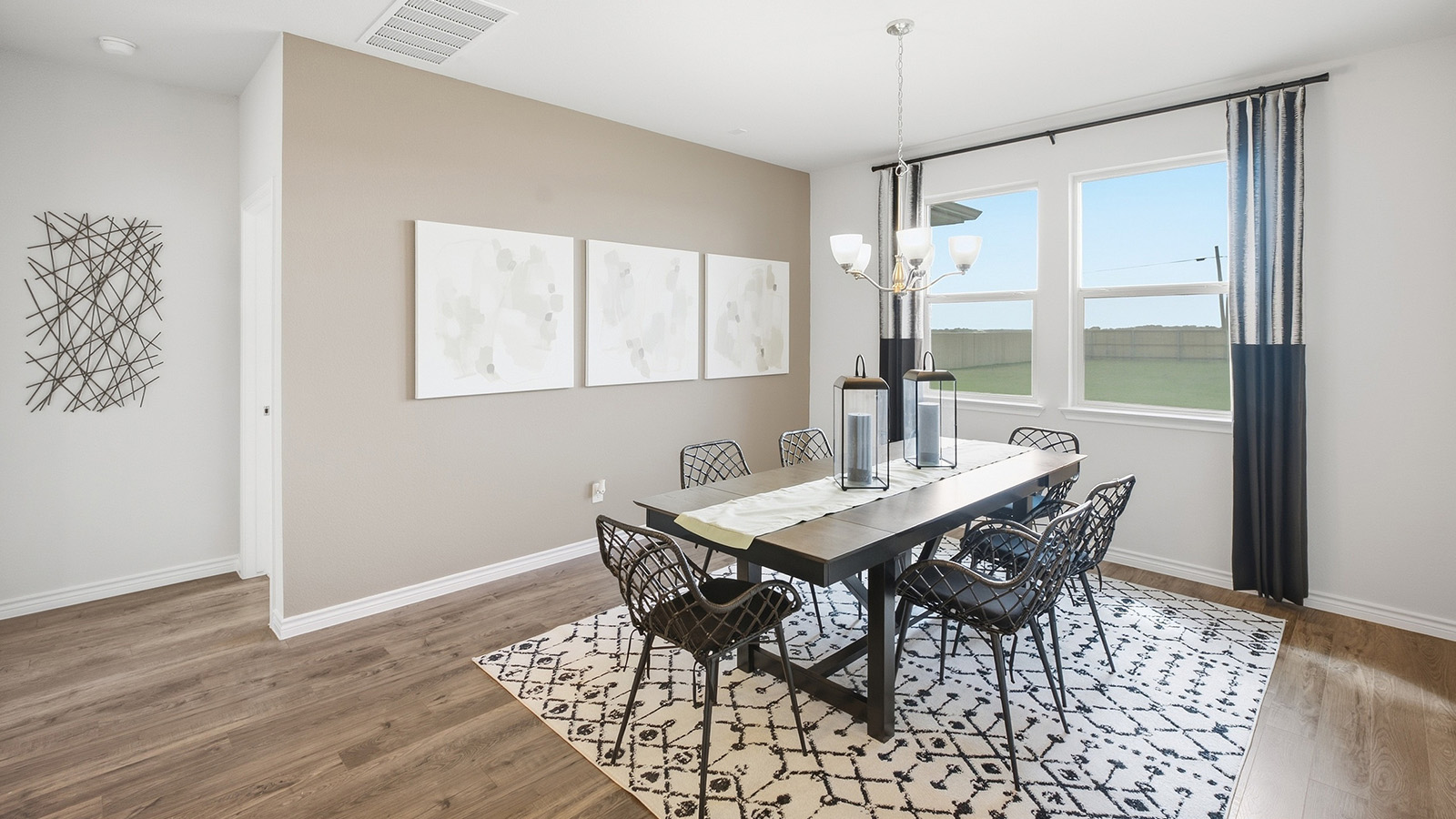 Homestead Model dining room with dining room table and windows for natural lighting.