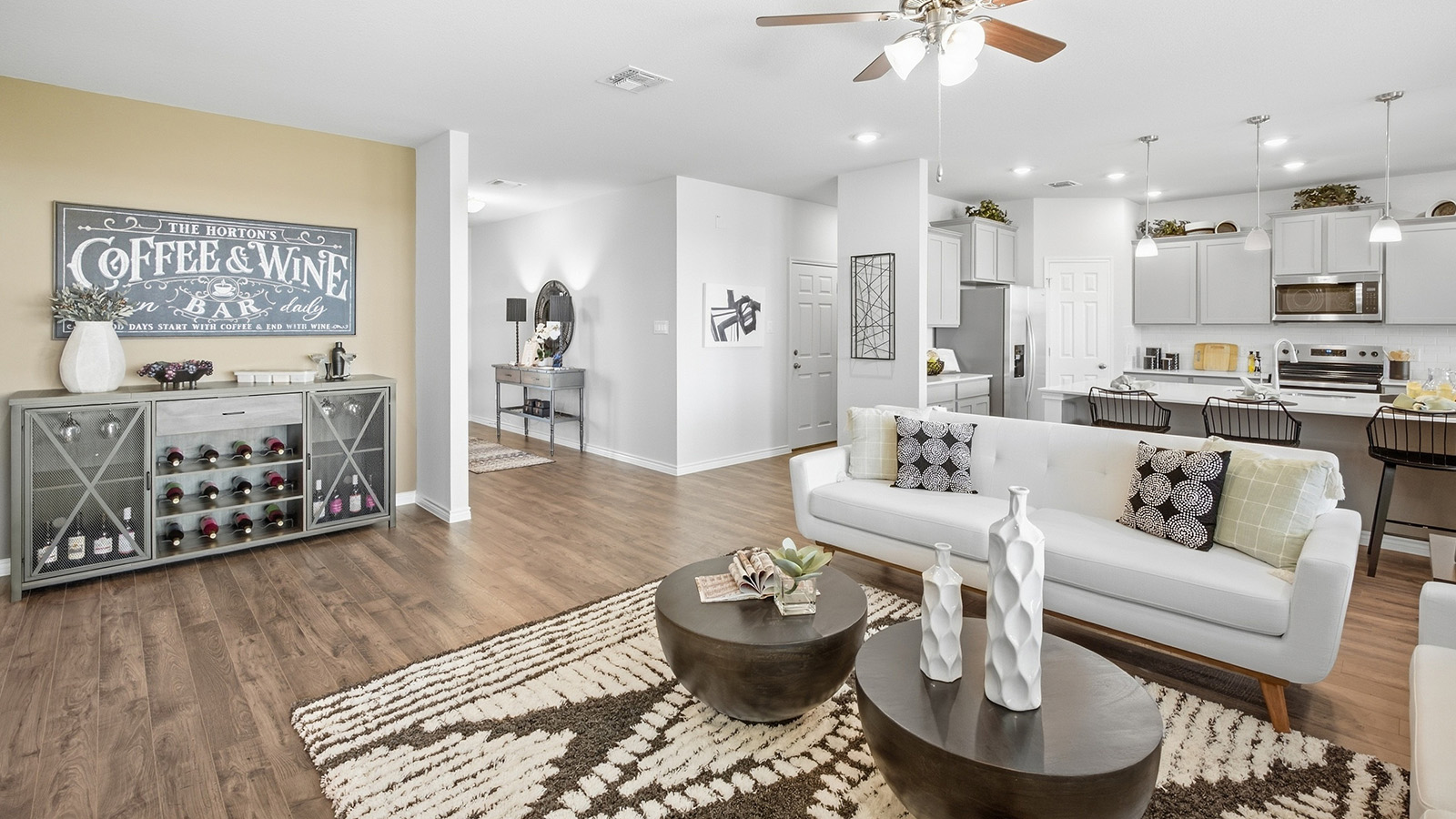 Homestead Model living room with view of open concept dining room and kitchen.