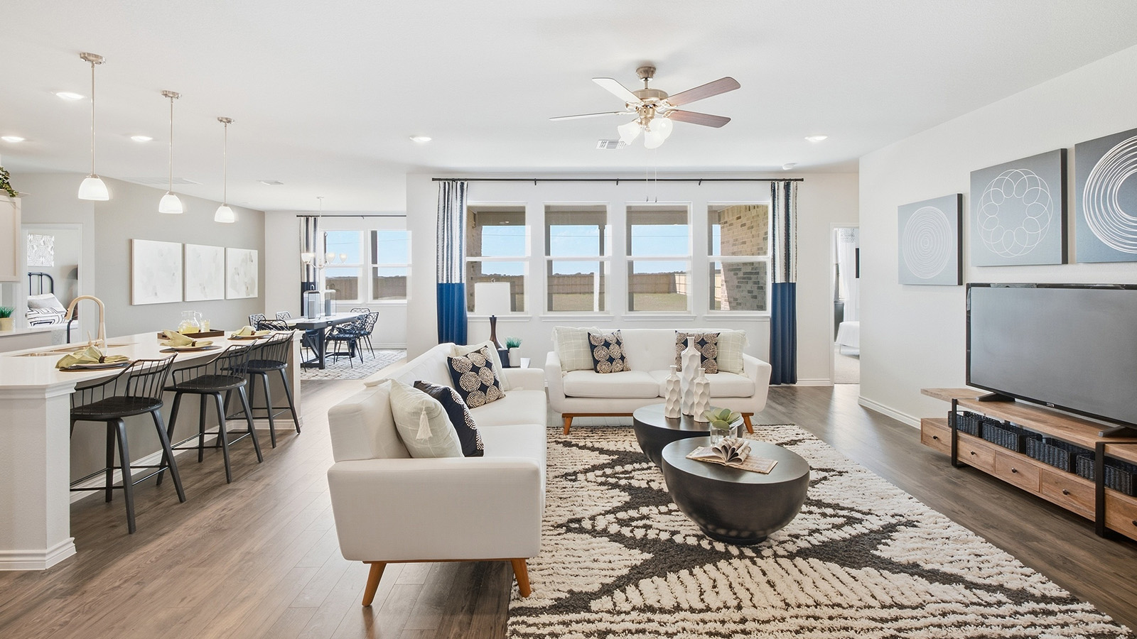 Homestead Model living room with view of open concept dining room and kitchen.
