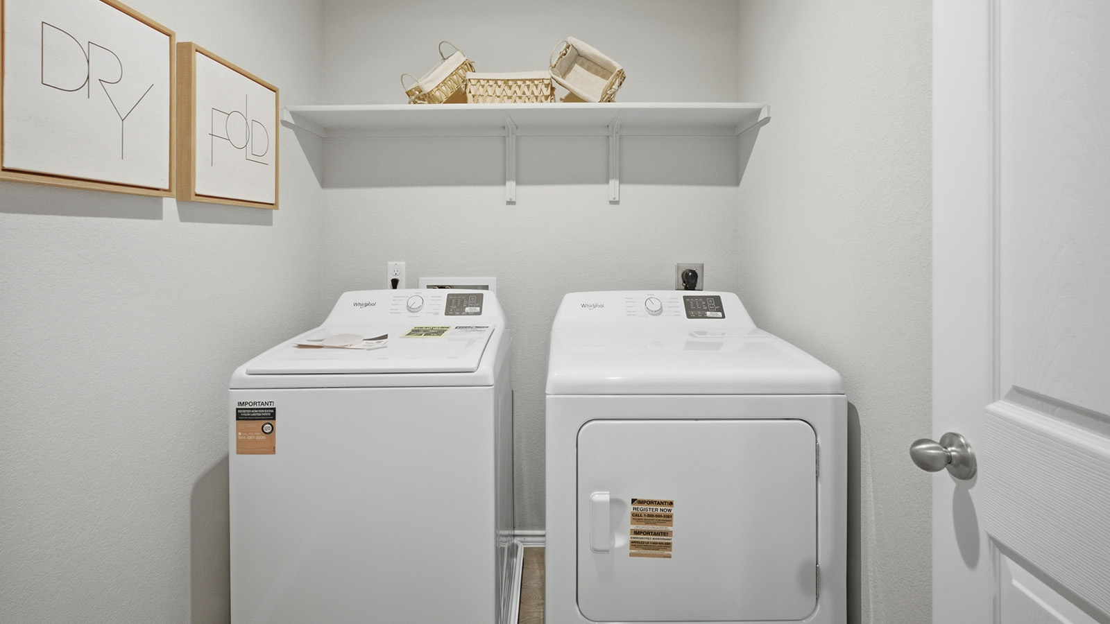 Cool Water model utility room with washer and dryer and shelving for storage.