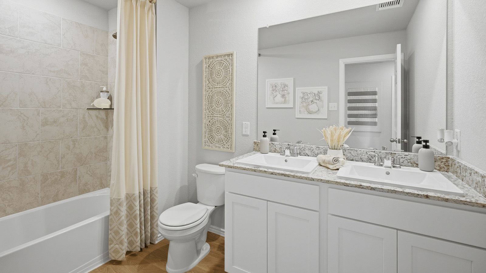Cool Water model secondary bathroom with duel vanity sink and shower and tub combo.