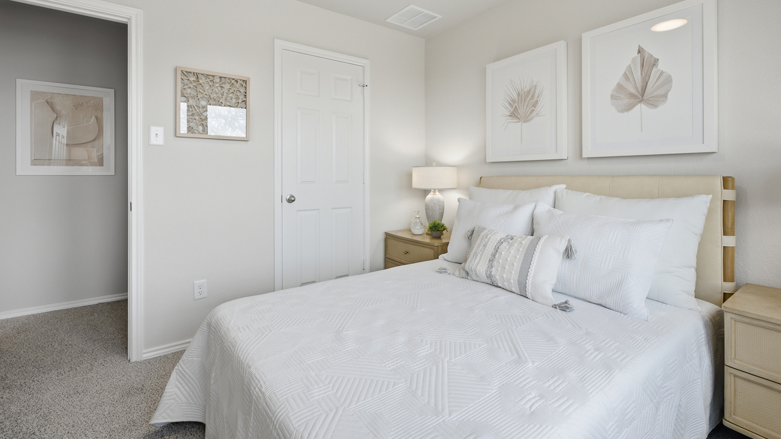 Cool Water model secondary bedroom with carpeted flooring and view of hallway.