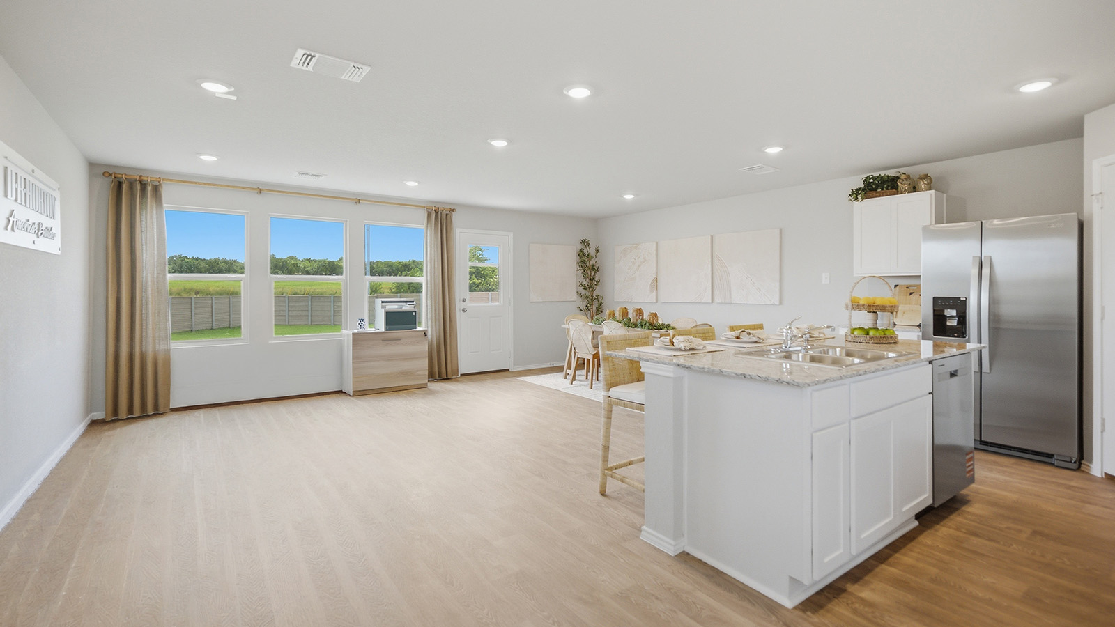 Cool Water model home living room with view of open concept kitchen and dining room.