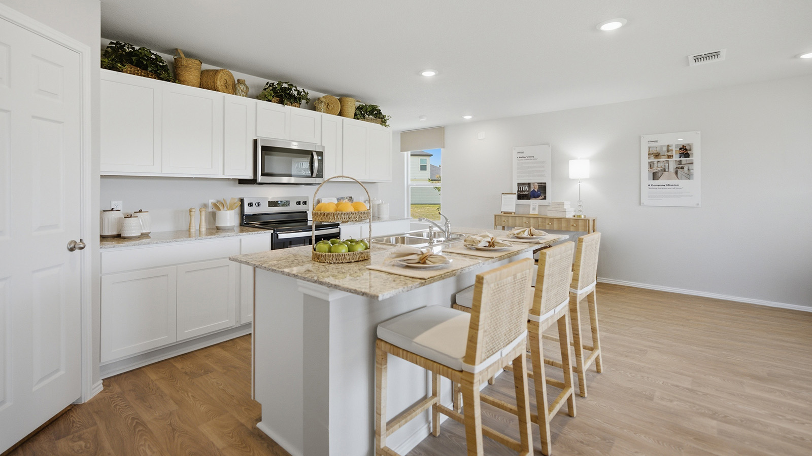 Cool Water model home kitchen with white cabinets and granite countertops.