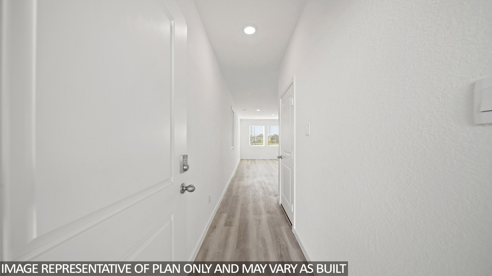 Gardenia front entry way with vinyl plank flooring and view of open concept living room and dining  room.