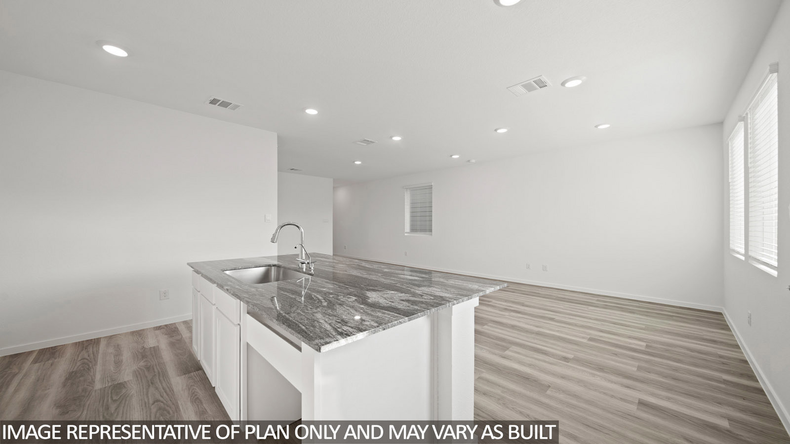 Gardenia kitchen with kitchen island with dark countertops with view of open concept living room and dining room.