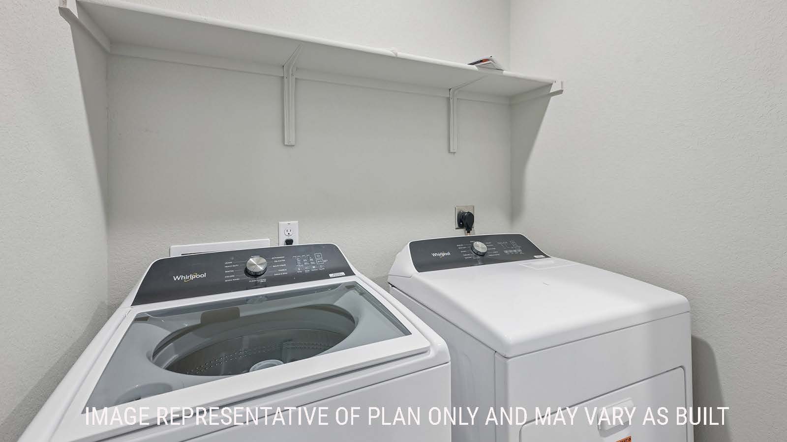 Gardenia utility room with washer and dryer and shelving for storage.