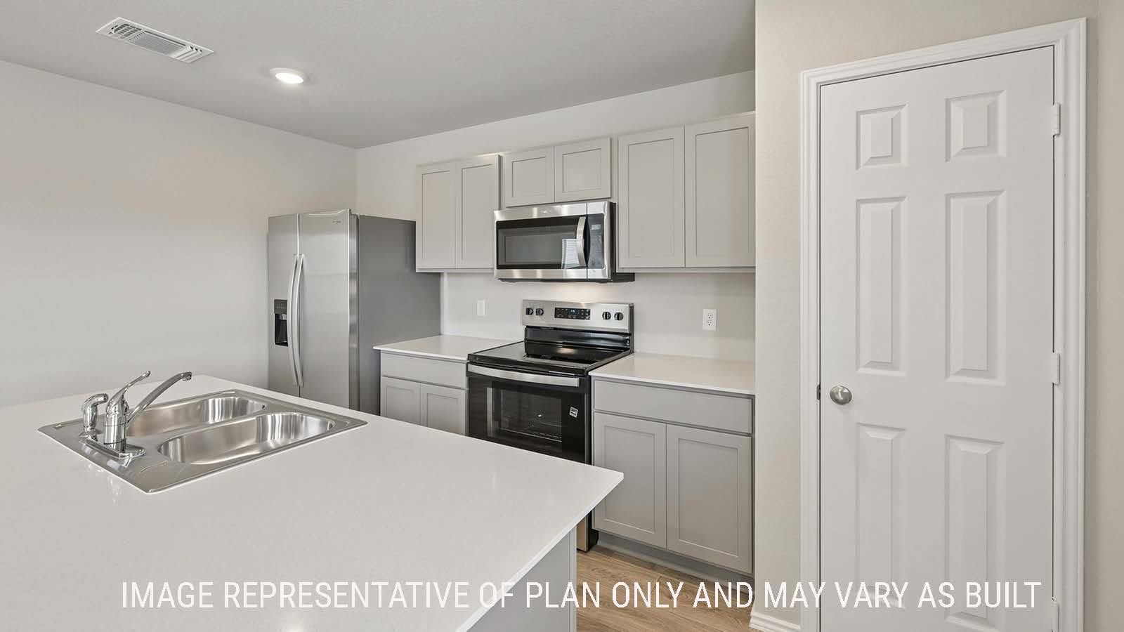Gardenia kitchen with kitchen island with grey cabinets and granite countertops.