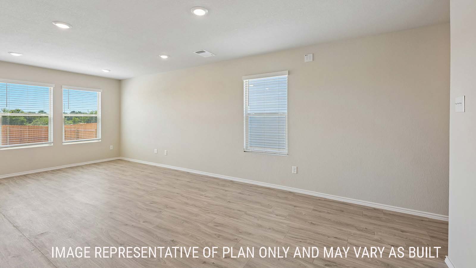 Gardenia living room with windows for natural lighting and view of back yard.