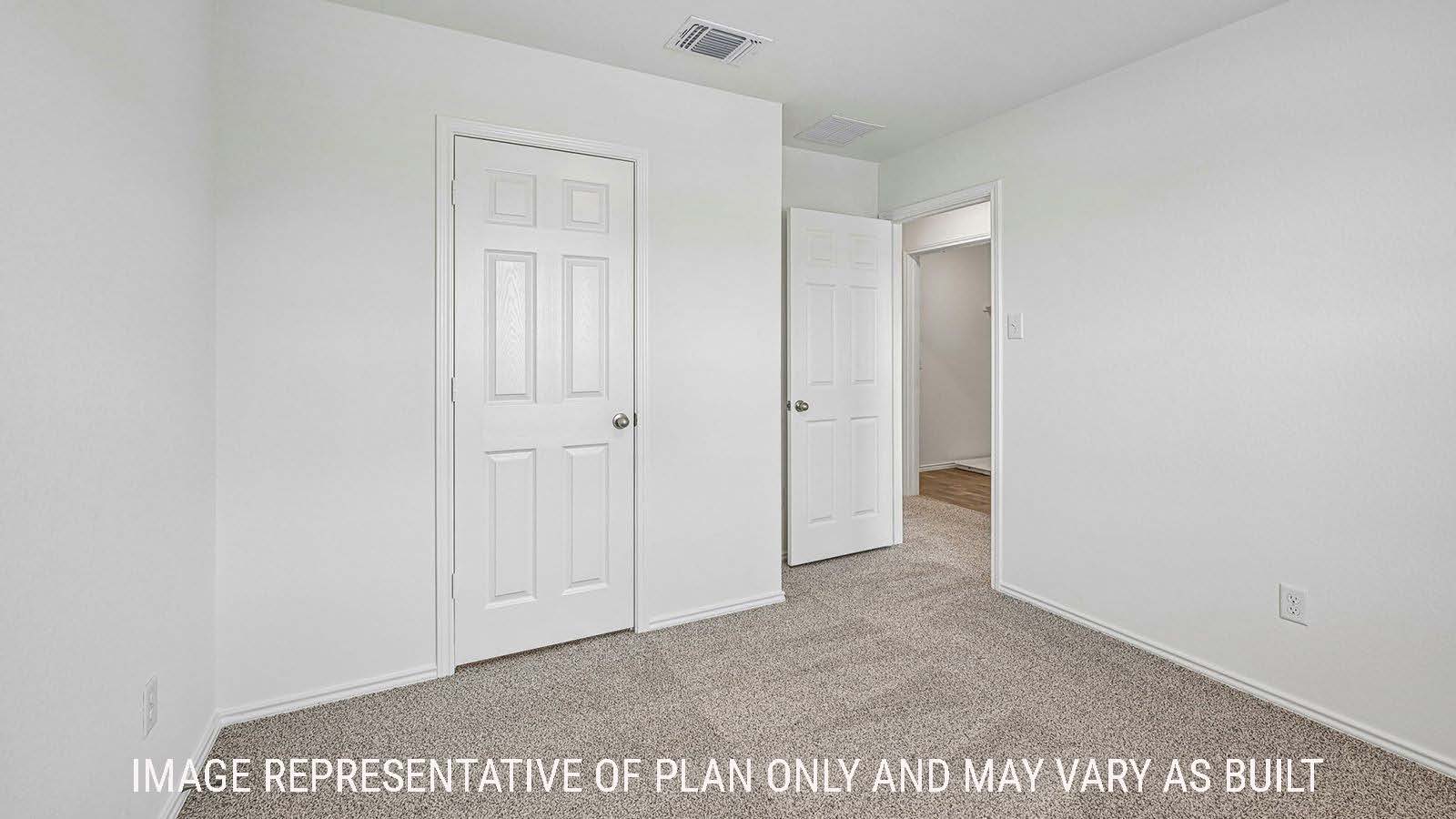Hibiscus secondary bedroom with carpeted flooring and view of hallway.