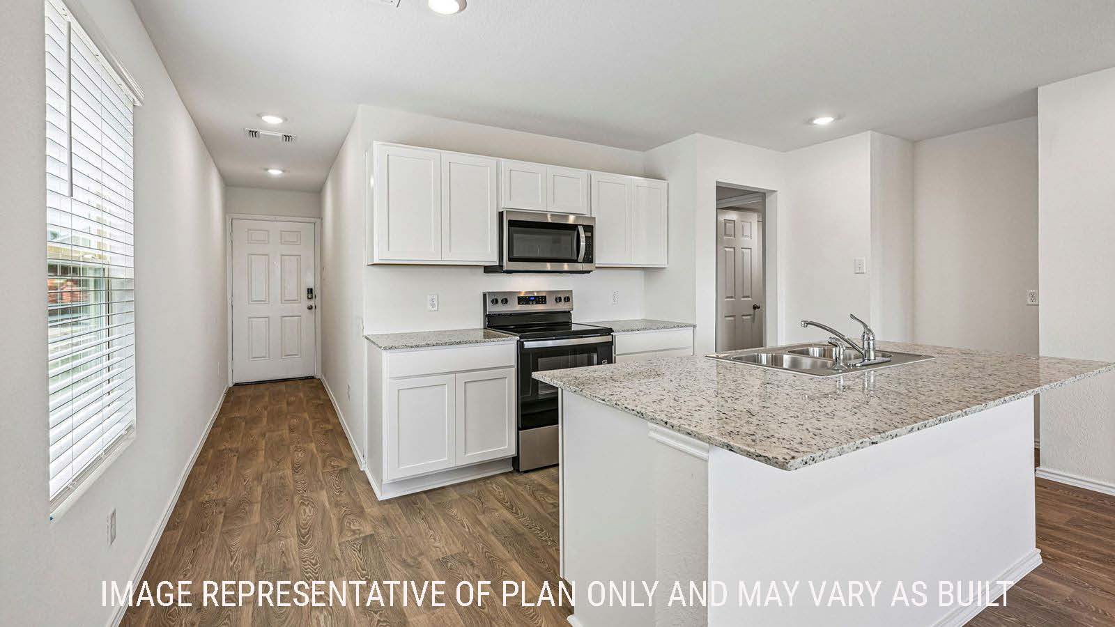 Hibiscus kitchen with kitchen island and light cabinets with view of front entry hallway.