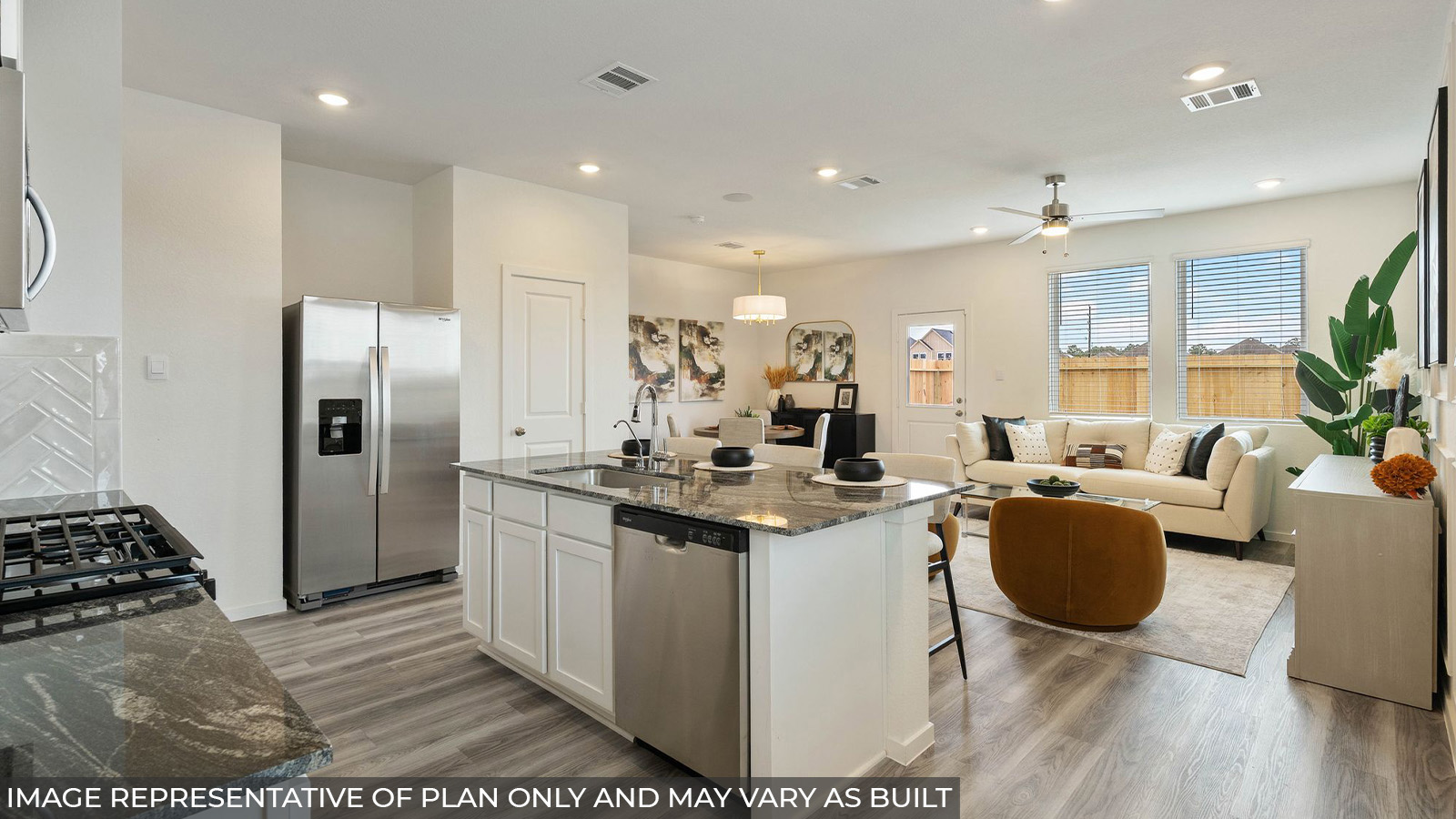 Hibiscus kitchen with kitchen island and view of open concept living room and dining room.