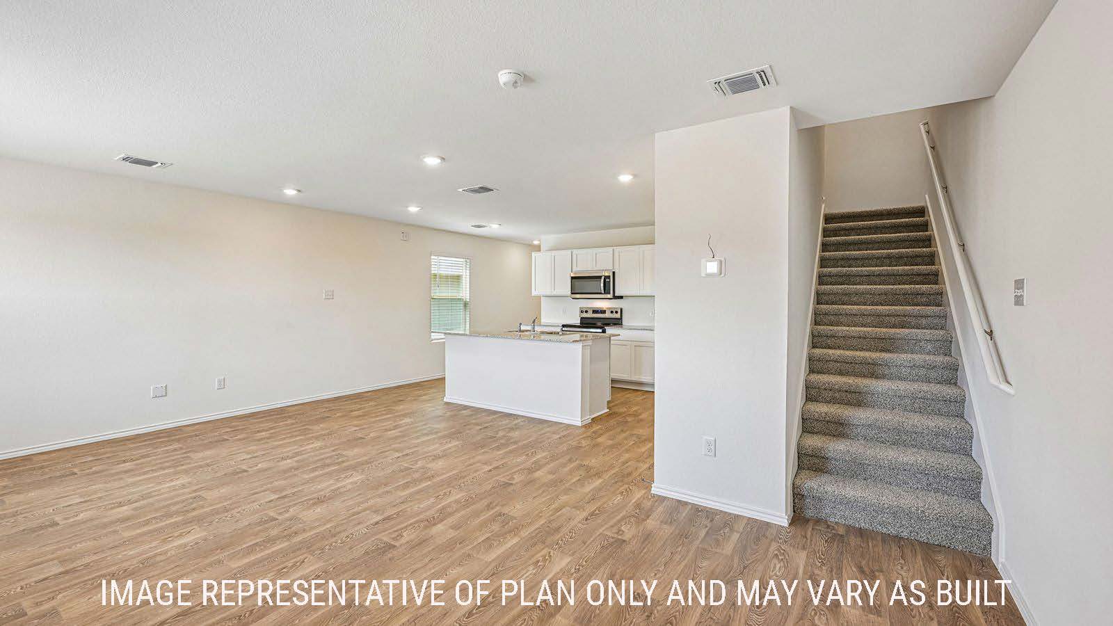 Hibiscus dining room with view of open concept living room and kitchen and view of stairs to the second floor.