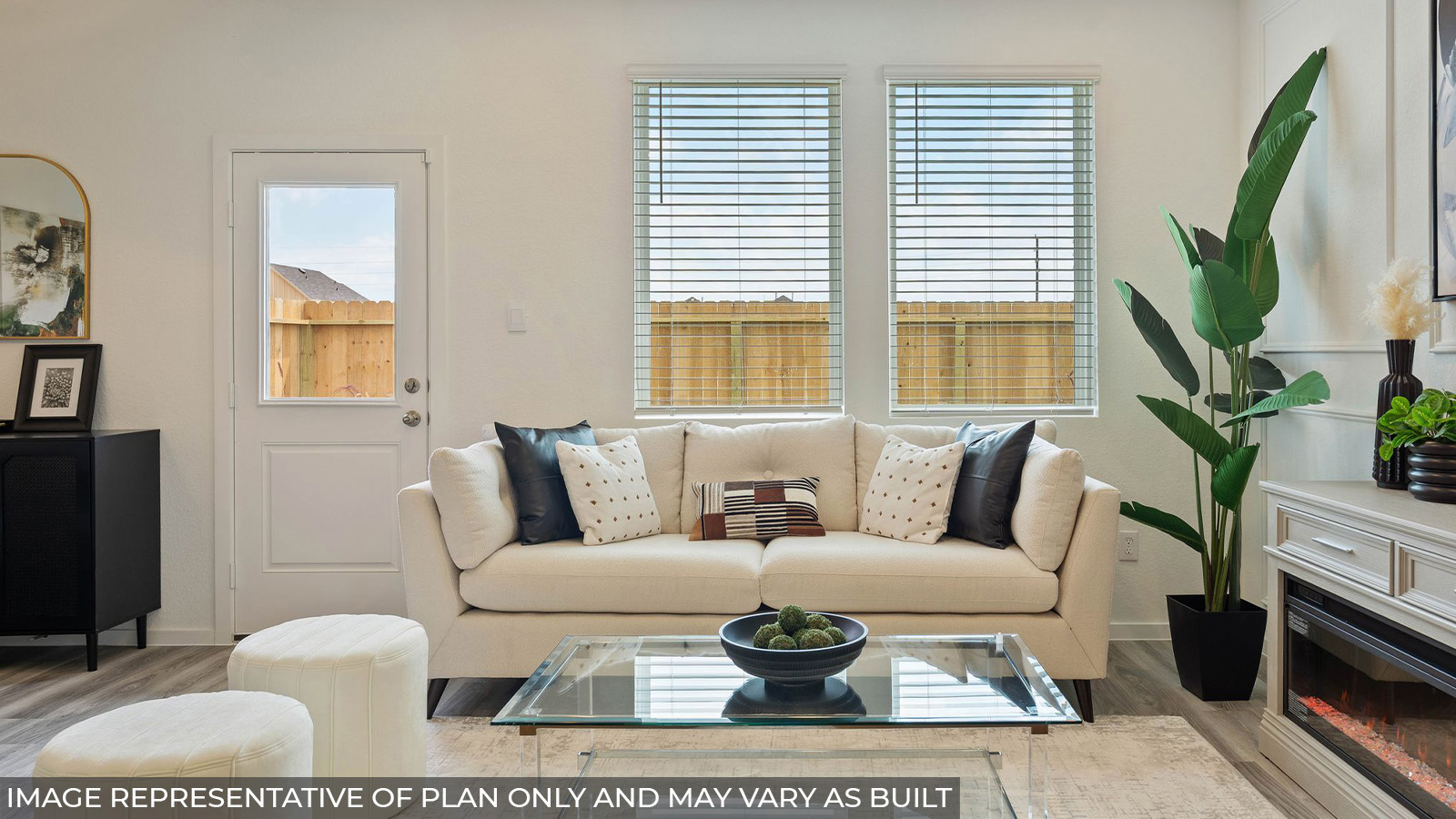 Hibiscus living room with vinyl plank flooring and windows with view of back yard.
