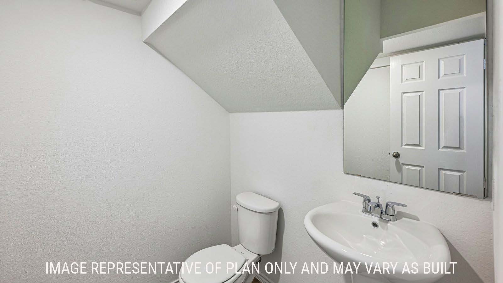 Hibiscus half bathroom with sink and mirror.