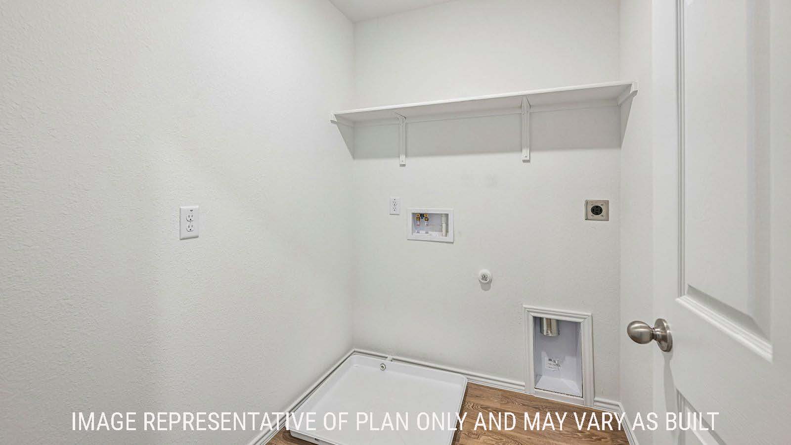Hibiscus utility room with washer and dryer connections and shelving for storage.