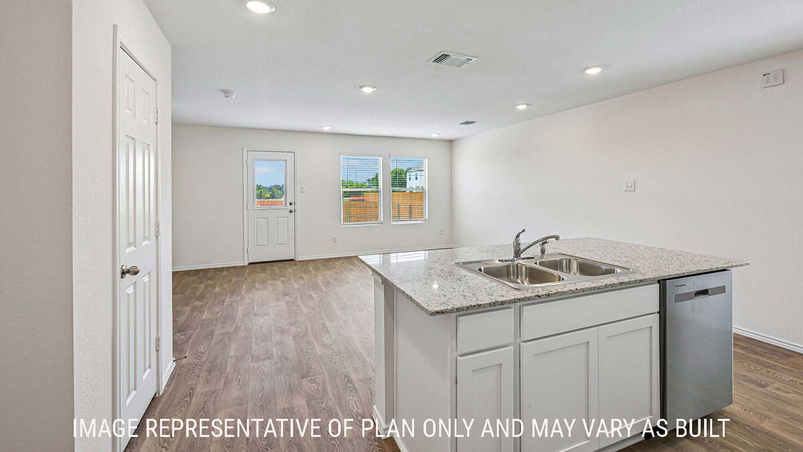 Hibiscus kitchen with kitchen island and view of open concept living room and dining room.